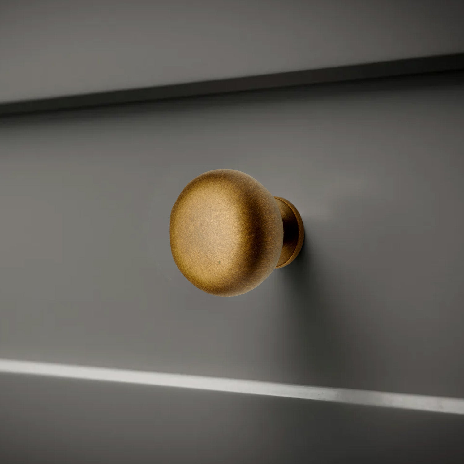 Mushroom Knob in a vintage antique english finish on a bathroom drawer.