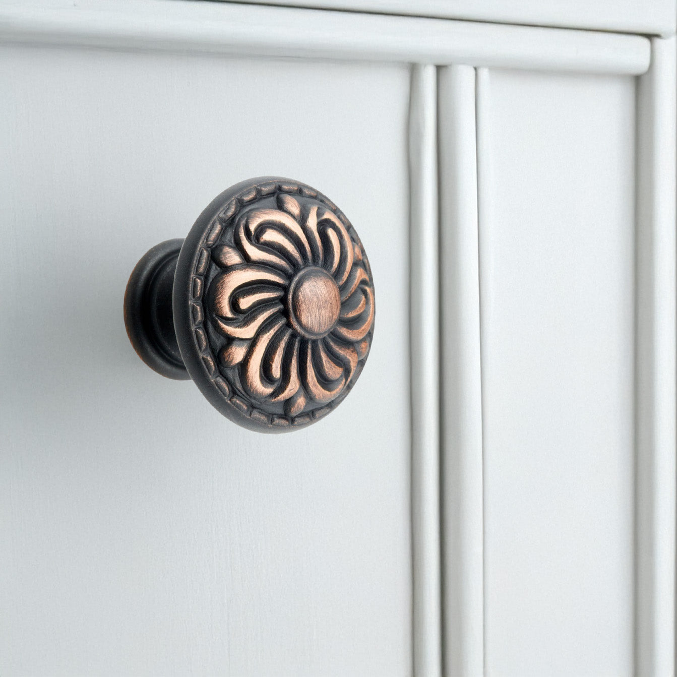 Valencia Bronze Round Traditional Knob on White Kitchen Cabinets