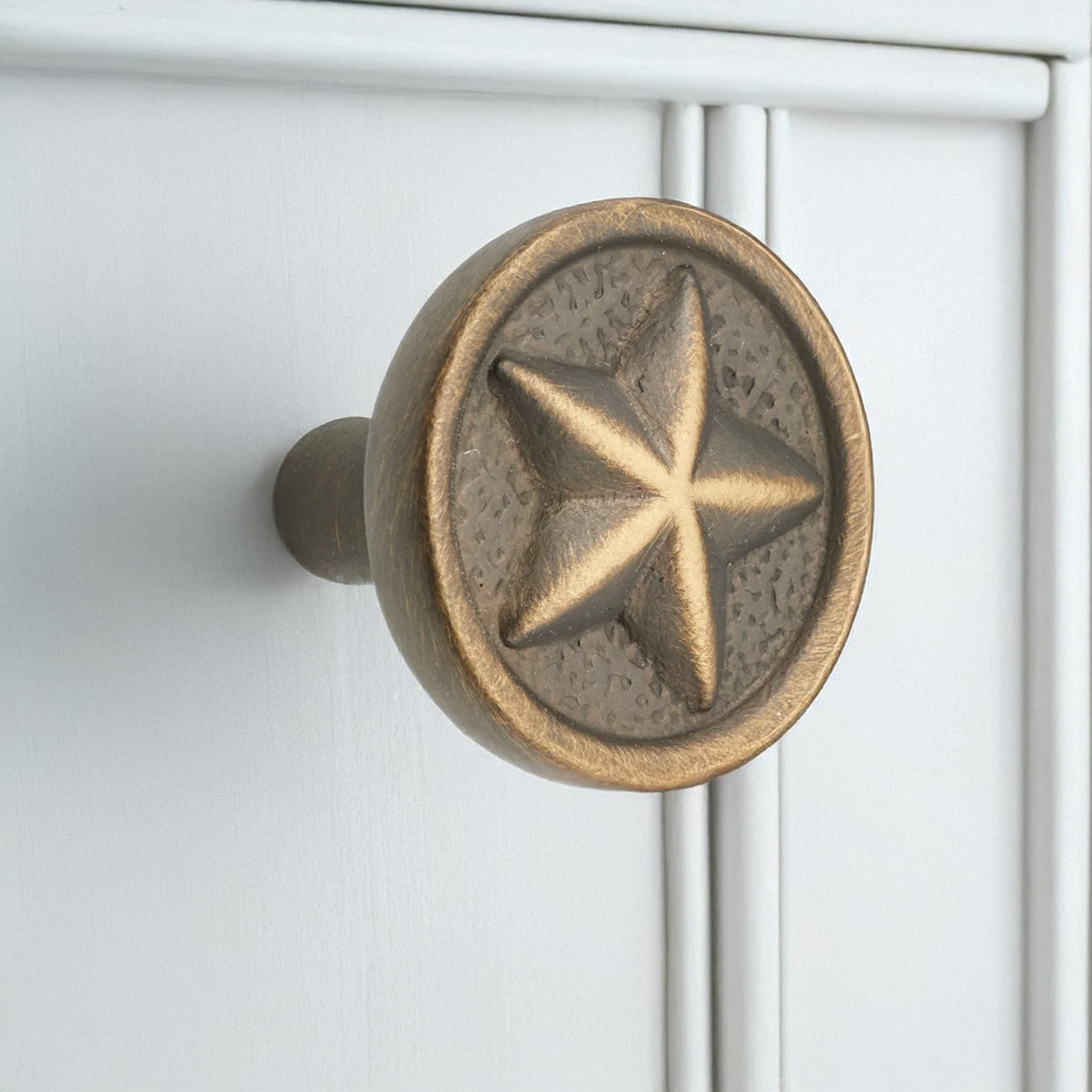 Antique English Texas Star Cabinet Knob on White Cabinets